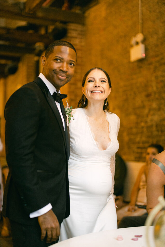 The bride and groom smile, captured by New York City wedding photographer, Molli Photo.