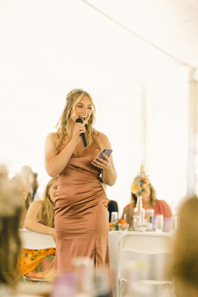 The bride's sister and maid of honor gives a speech during the toasts.