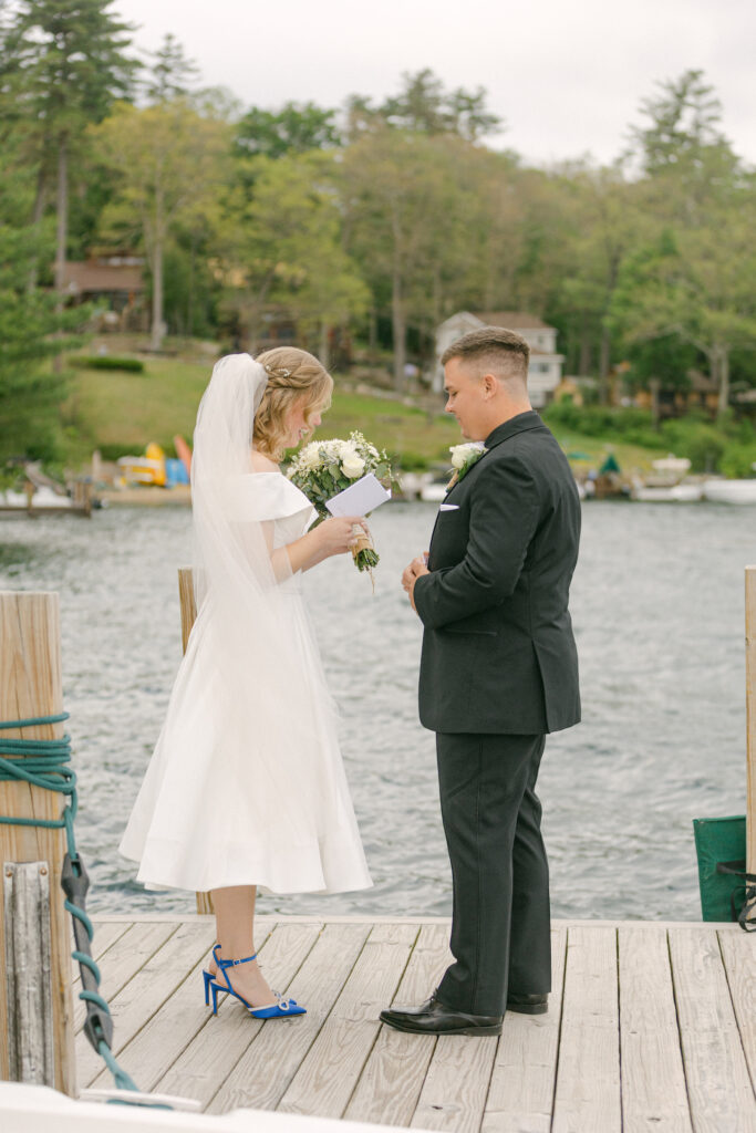 The bride and groom read each other handwritten notes after their first look in front of Lake George.