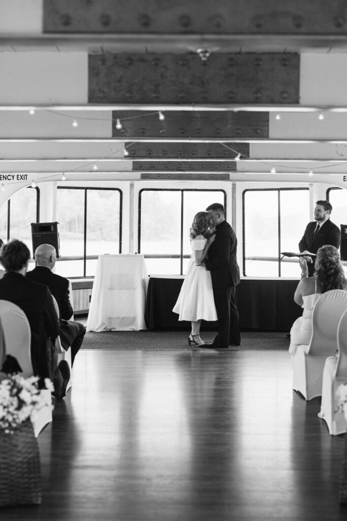 The bride and groom say "I do" on a cruise boat wedding sailing Lake George.