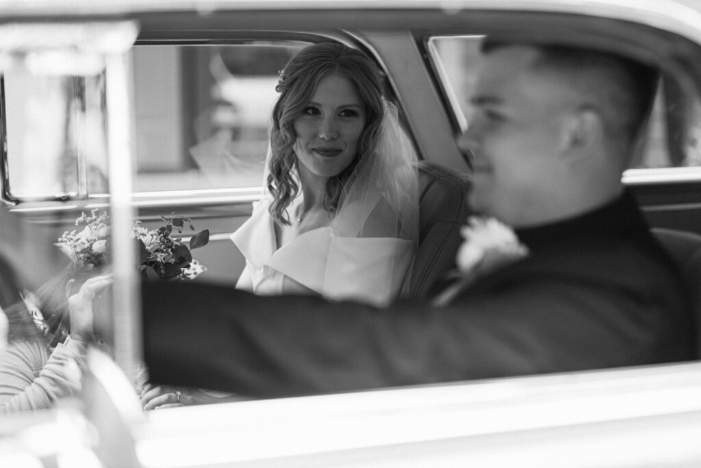 Wedding photography portraits with for the bride and groom in a vintage car after the first look.