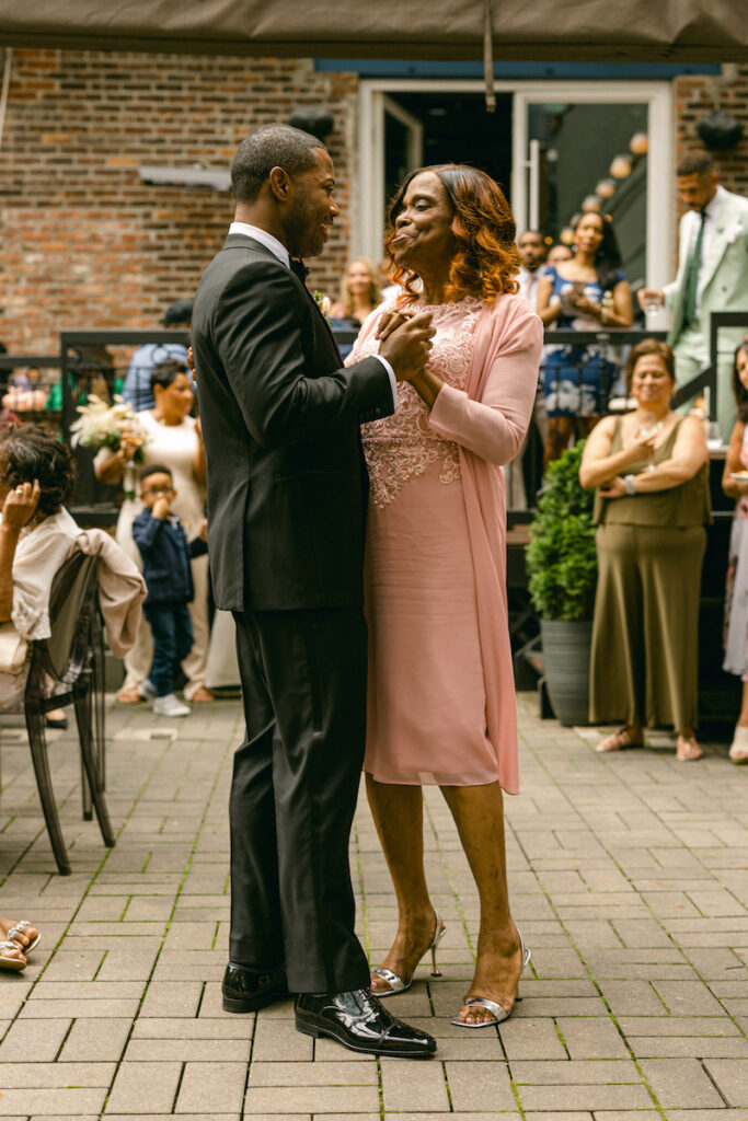 The groom and the mother of the groom dance, captured by New York City wedding photographer, Molli Photo.