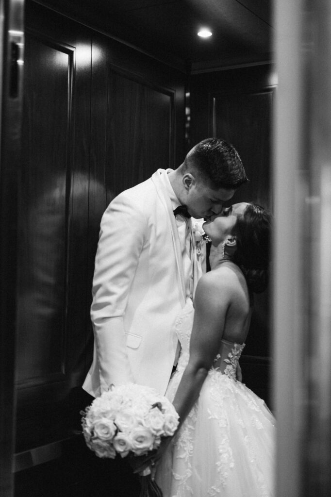 Bride and groom in the elevator of the Queensbury Hotel in Lake George, New York.