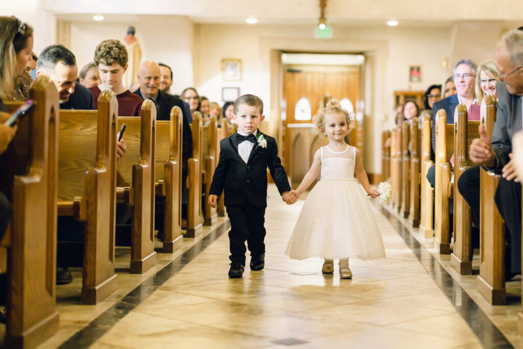 The flower girl and ring bearer walking down the aisle for a New York wedding ceremony.