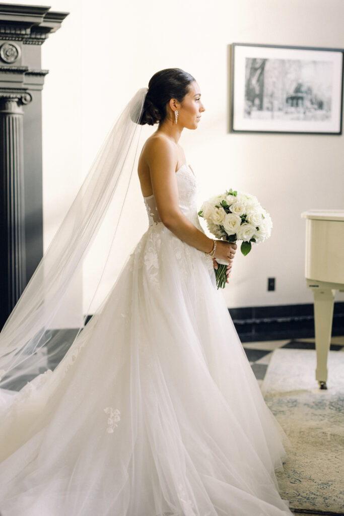 The bride in cathedral length gown before her wedding day at the Queensbury Hotel in Lake George, New York.