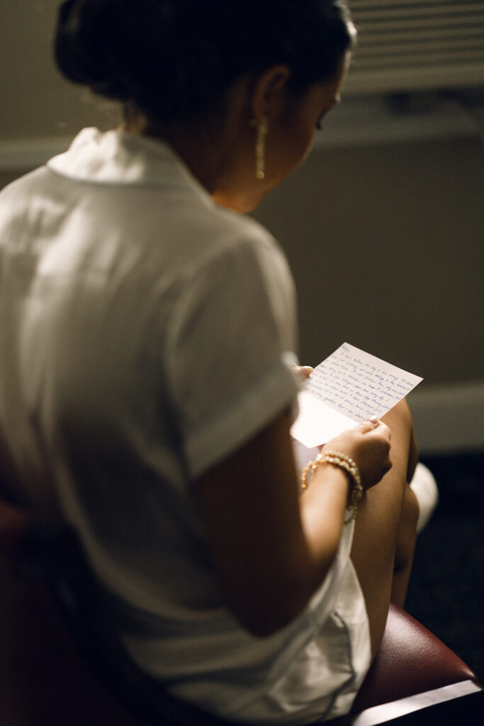 The bride reading a letter written by the groom while she gets ready for the wedding.