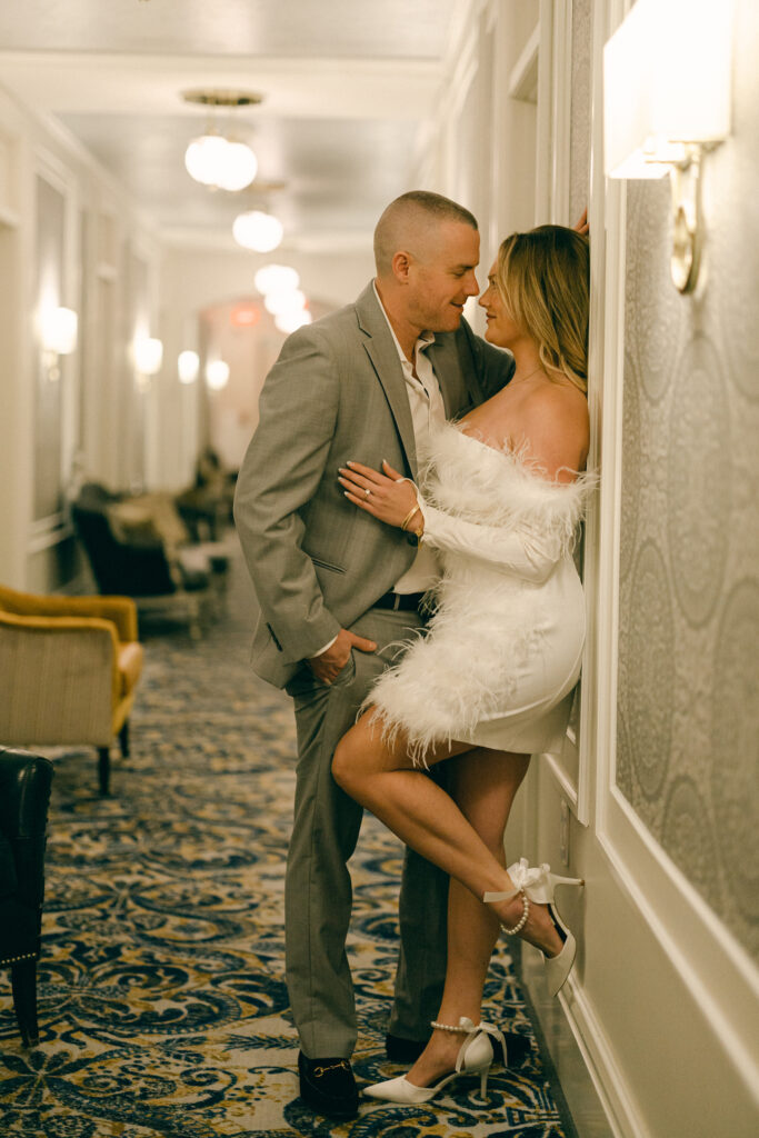 Couple leaned against a Adelphi hotel hallway for an engagement photo in New York.
