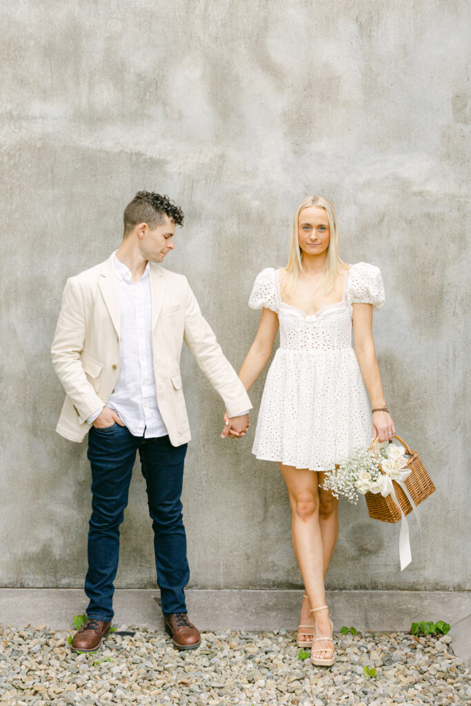 A couple leaning against a wall for outdoor engagement photos in New York.
