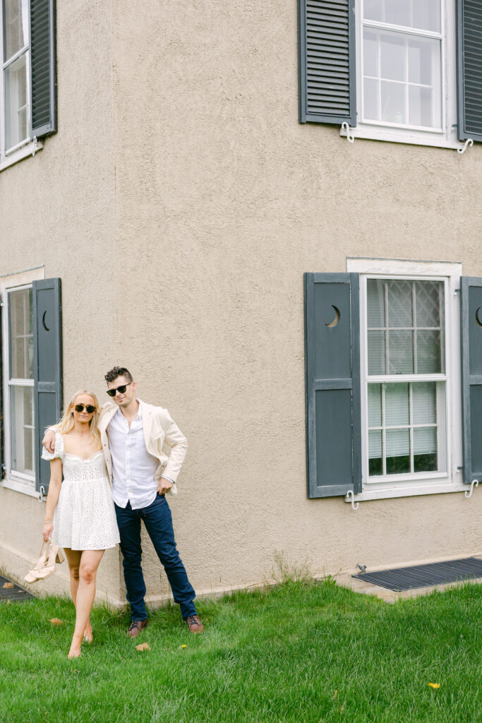 A couple dressed in modern outfits and wearing sunglasses for an engagement photo session.