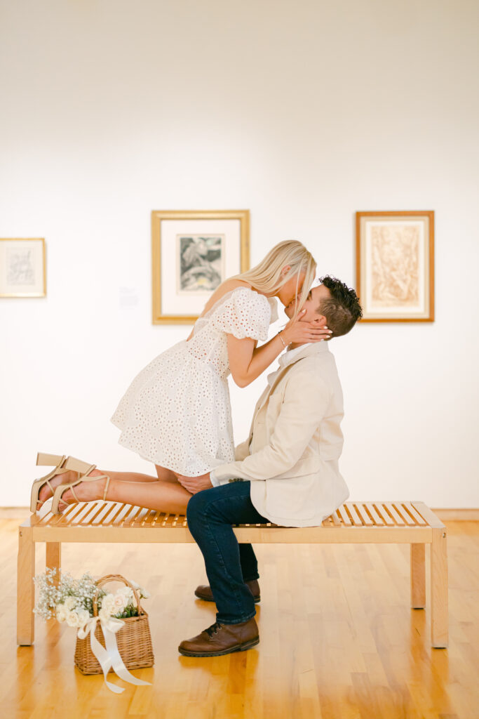 Blythe and Peter posing for their engagement photos in Glen Falls museum.