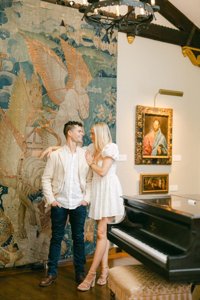 Peter and Blythe standing in front of an art mural at The Hyde Collection Museum of Art in the Adirondacks for their engagement photos.