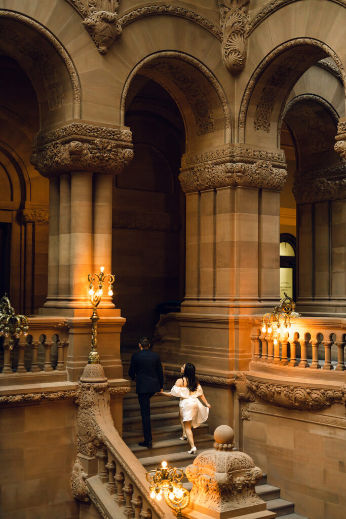 Walking up the staircase at the State Capitol Building in New York for an engagement photo.