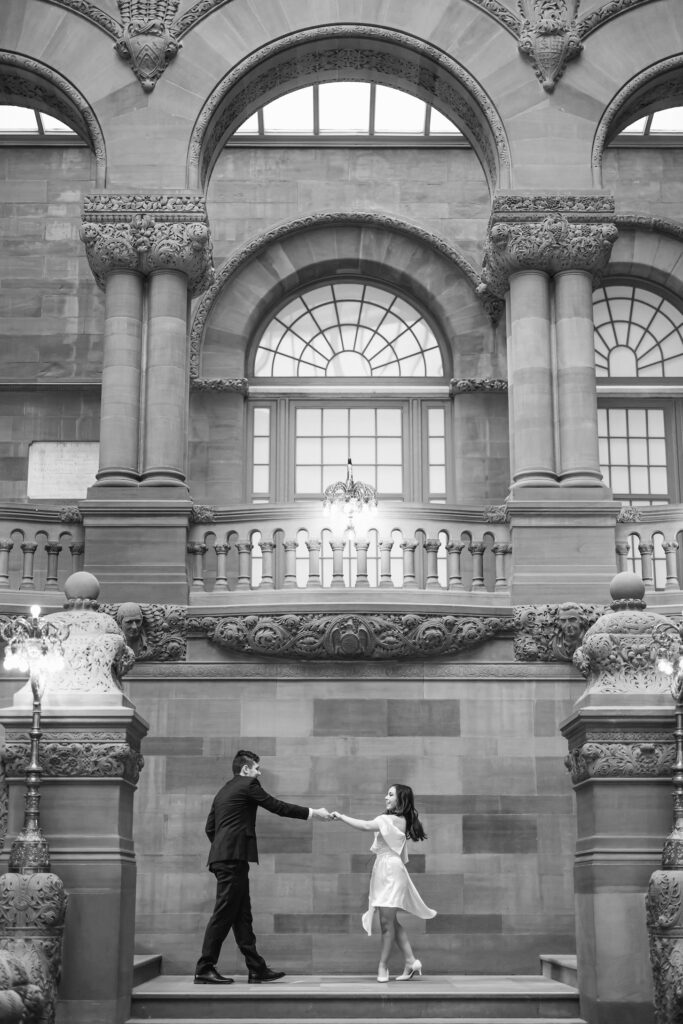 Bride and groom dancing in the New York City for an engagement photo.