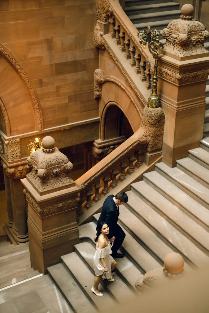Couple walking up the steps at the New York State Capitol Building.