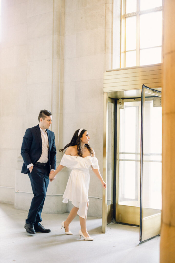 The bride and groom leaving the Capitol Building during a New York engagement photoshoot.