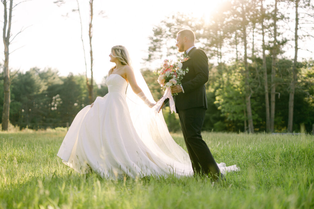 Air Strip Farm styled wedding photoshoot with birde and groom holding hands in a meadow.