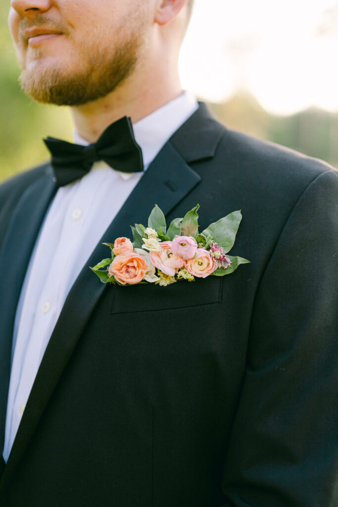 Pocket boutonnière of pink peonies for a garden party wedding.