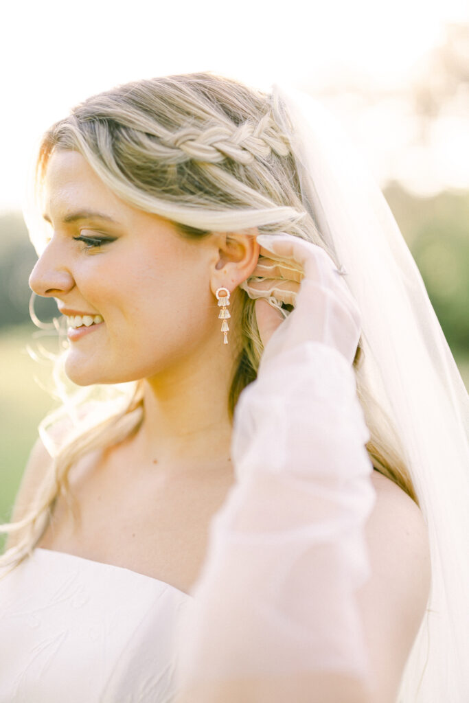 Bride with wedding braided hair and gold jewlery.