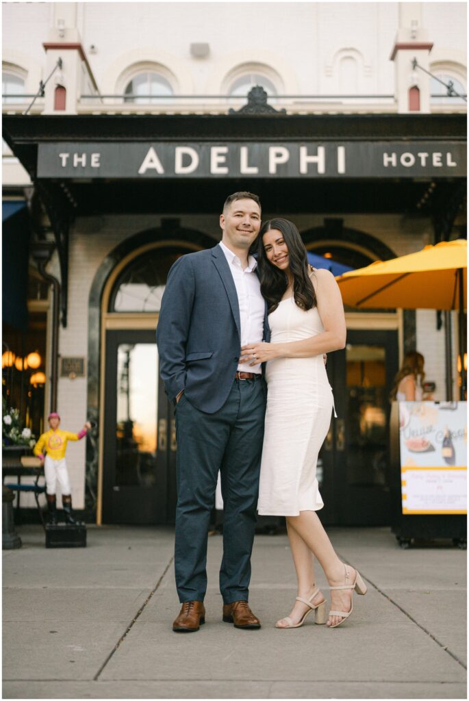 Newlyweds smile while standing under the marquee of the adelphi hotel wedding venue