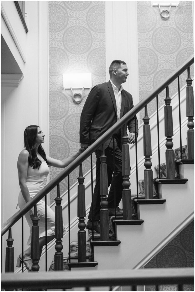 A groom leads his bride up the stairs by the hand at the adelphi hotel wedding venue