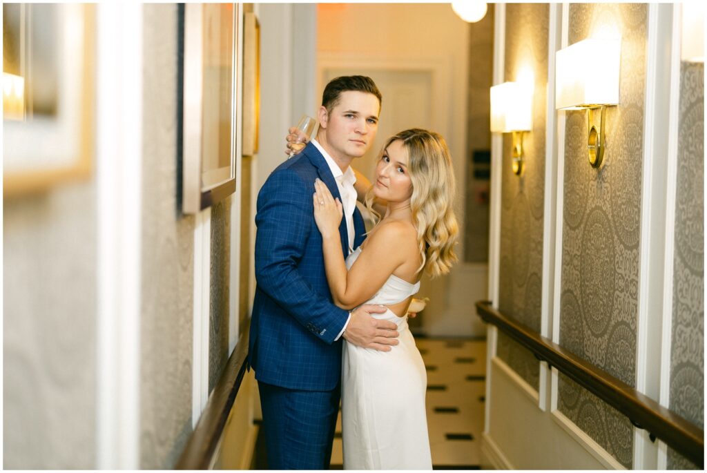 A bride and groom share a quiet intimate moment in a hallway